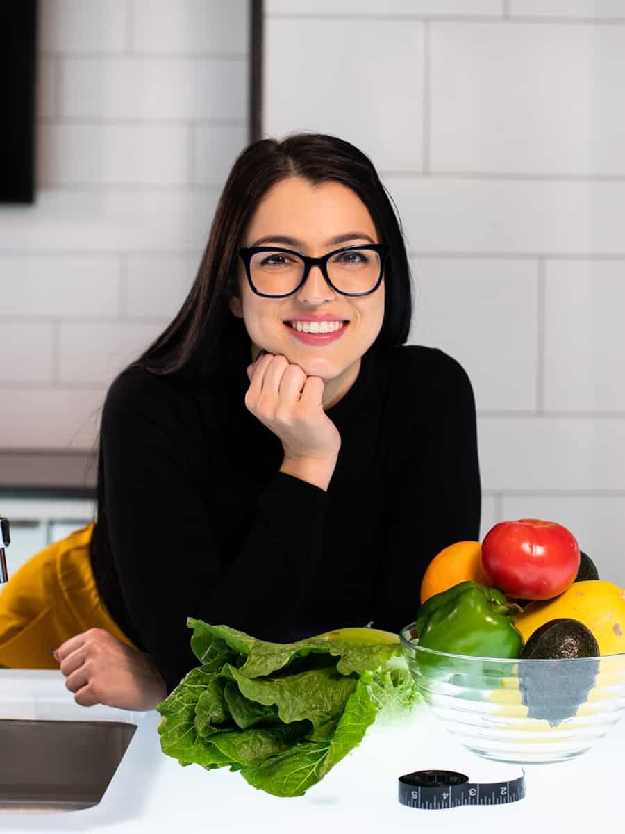 smiling woman with vegetables on bowl